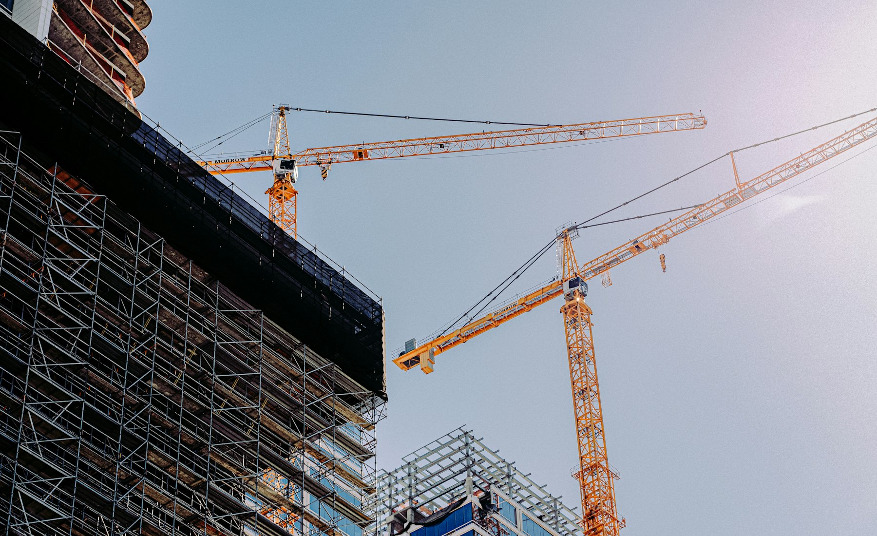 Construction frame, cranes over the scaffold